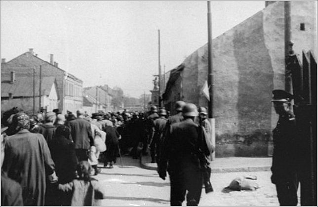 A column of Jews marches through the streets of Krakow during the final liquidation of the ghetto